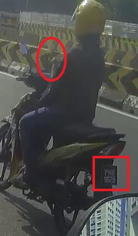Orh hor! Multitasking biker caught using phone while riding on the road!