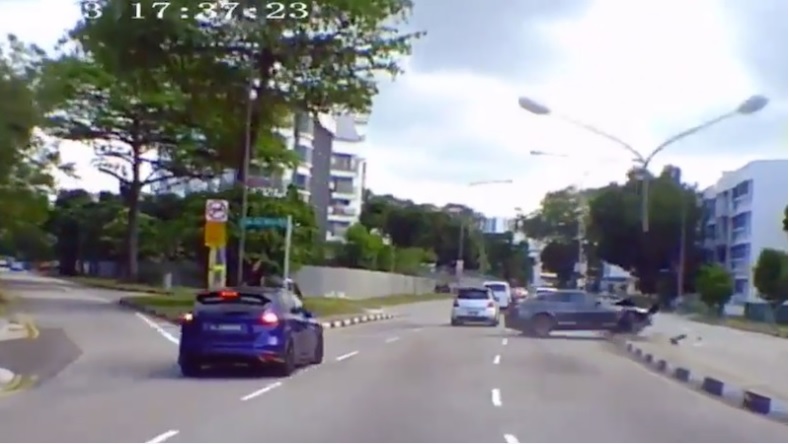 WATCH: Zooming car loses control at a bend, knocks down lamp post