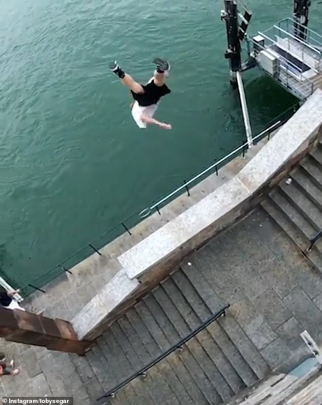 British parkour expert shocks bystanders as he performs dangerous running jump over a wall and jetty before plunging 25ft into the Rhine in Switzerland
