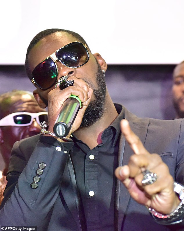 Grieving fans of Ivory Coast singer DJ Arafat open his coffin and UNDRESS his corpse a day after his funeral amid rumours the musician was not dead