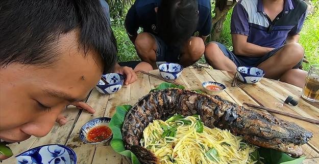 男子捉到条4斤的鲶鱼，腌好，用椰壳烤着吃，肉很嫩还有椰子香