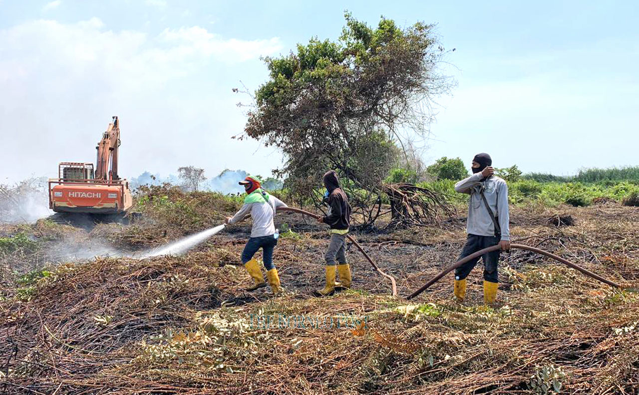 Putting out fire behind golf course still on