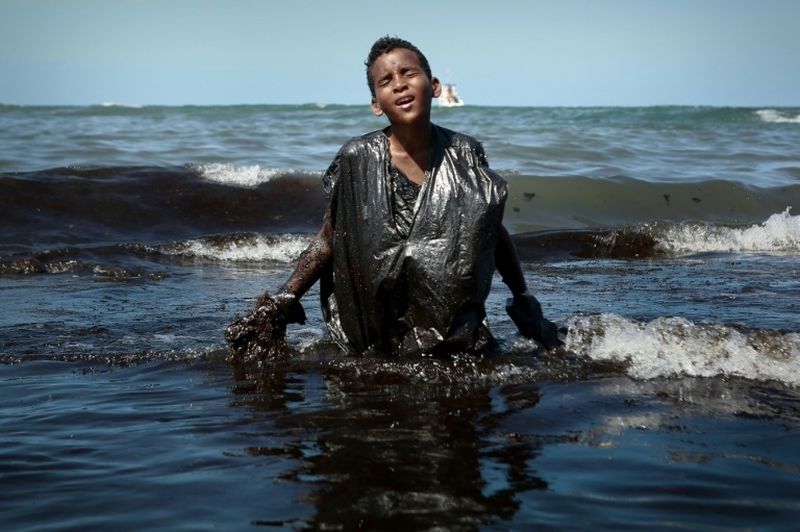 Photo of oil-drenched Brazilian boy goes viral