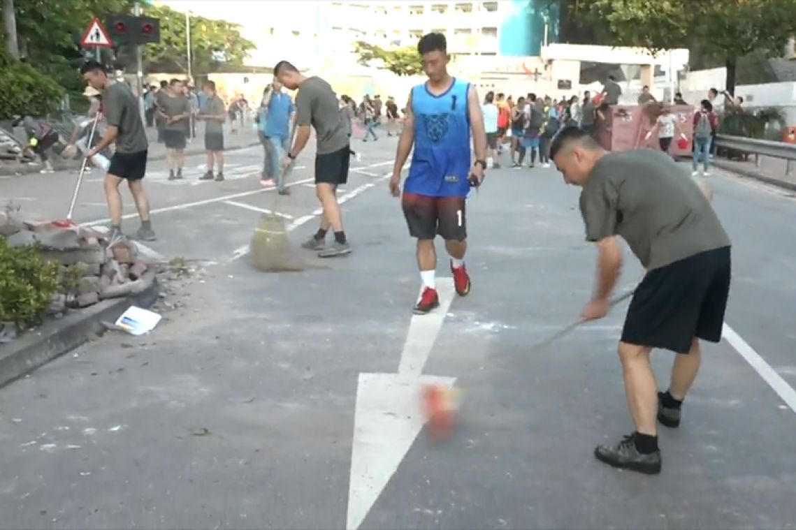 China’s PLA soldiers help clean up Hong Kong streets as protests rumble on