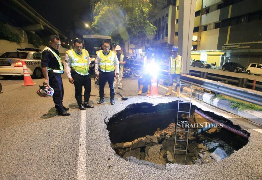 Car falls into sinkhole; driver unhurt
