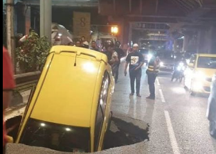Massive sinkhole swallows car in heart of Kuala Lumpur