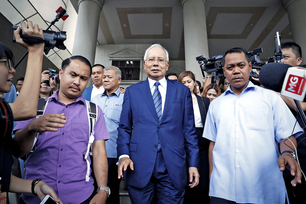Najib Razak swears in mosque he did not order murder
