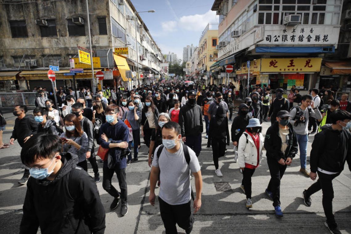 Thousands of protesters march in Hong Kong near border, taking aim at Chinese traders