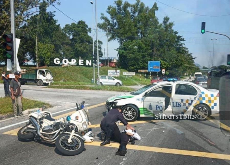 Traffic police officer injured after police escort car hit him in Kampar