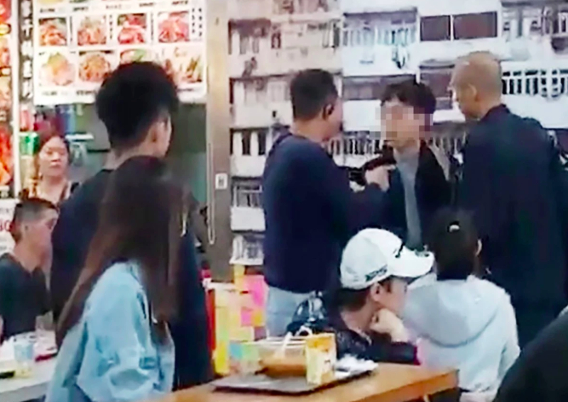 Man arrested after taking picture of Hong Kong police in restaurant