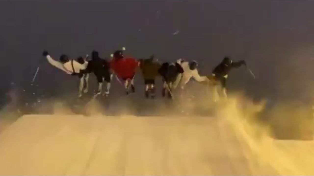 Group Of Skiers Jump Together