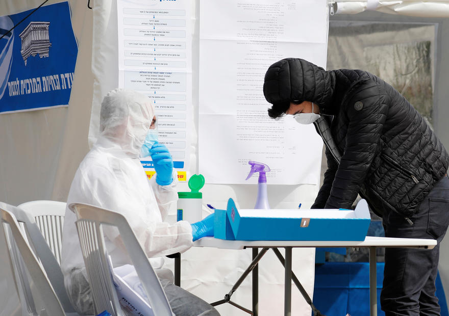 Masked and gloved: Israelis in quarantine from coronavirus vote in election