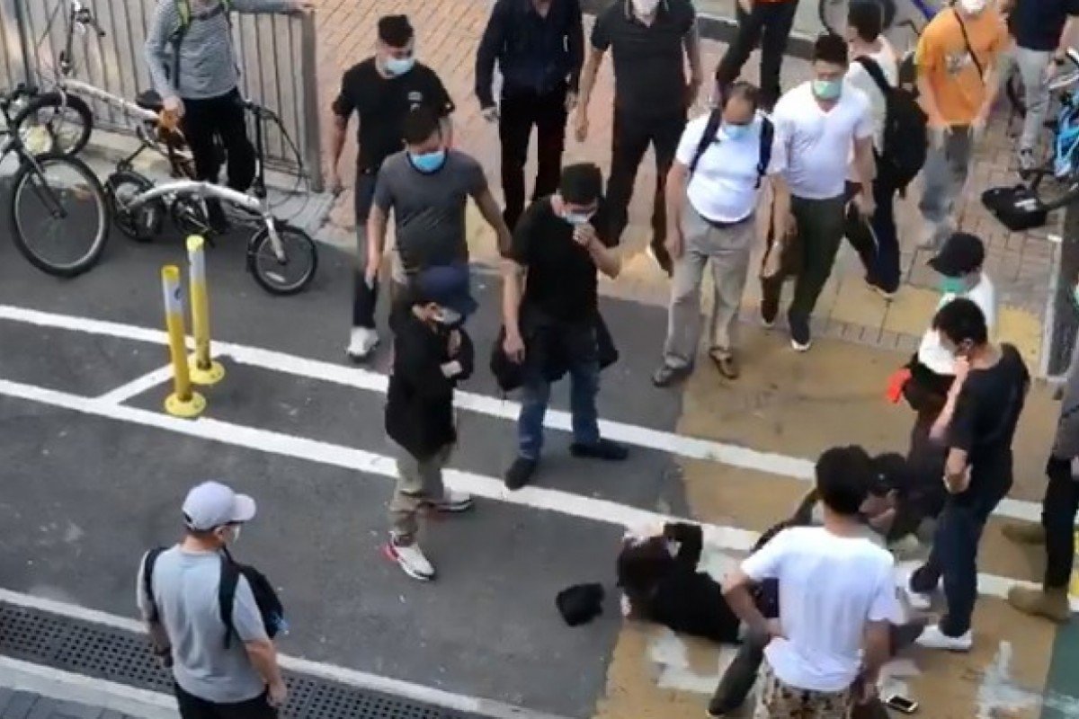 Three men arrested over attack on Hong Kong activists who tried to intervene in fracas on street