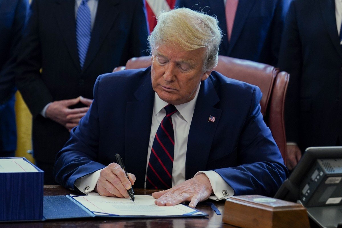 Donald Trump signs US$2 trillion coronavirus package after last-minute drama in House