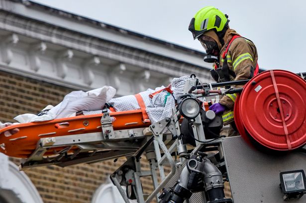 Coronavirus patient air-lifted out of flat window by firefighters in masks