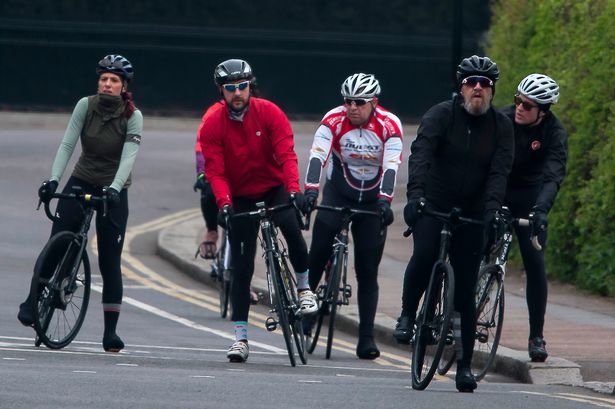 Cyclists ignore UK coronavirus lockdown rules as they ride together in the sun