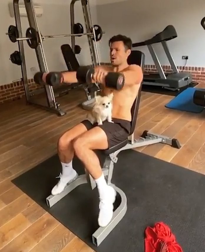 Mark Wright works out with a chihuahua on his lap as she won’t leave him alone