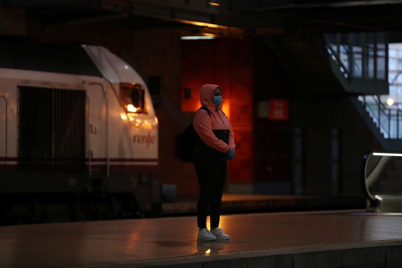 Some spaniards head back to work in face masks as country loosens lockdown