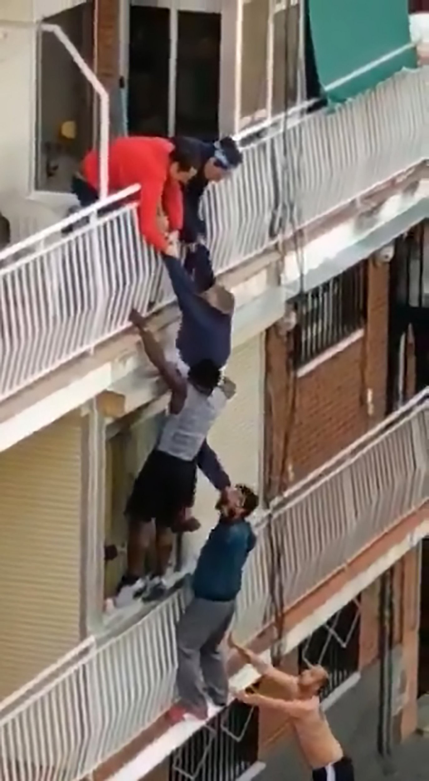 Heroes climb building to save pensioner hanging from balcony