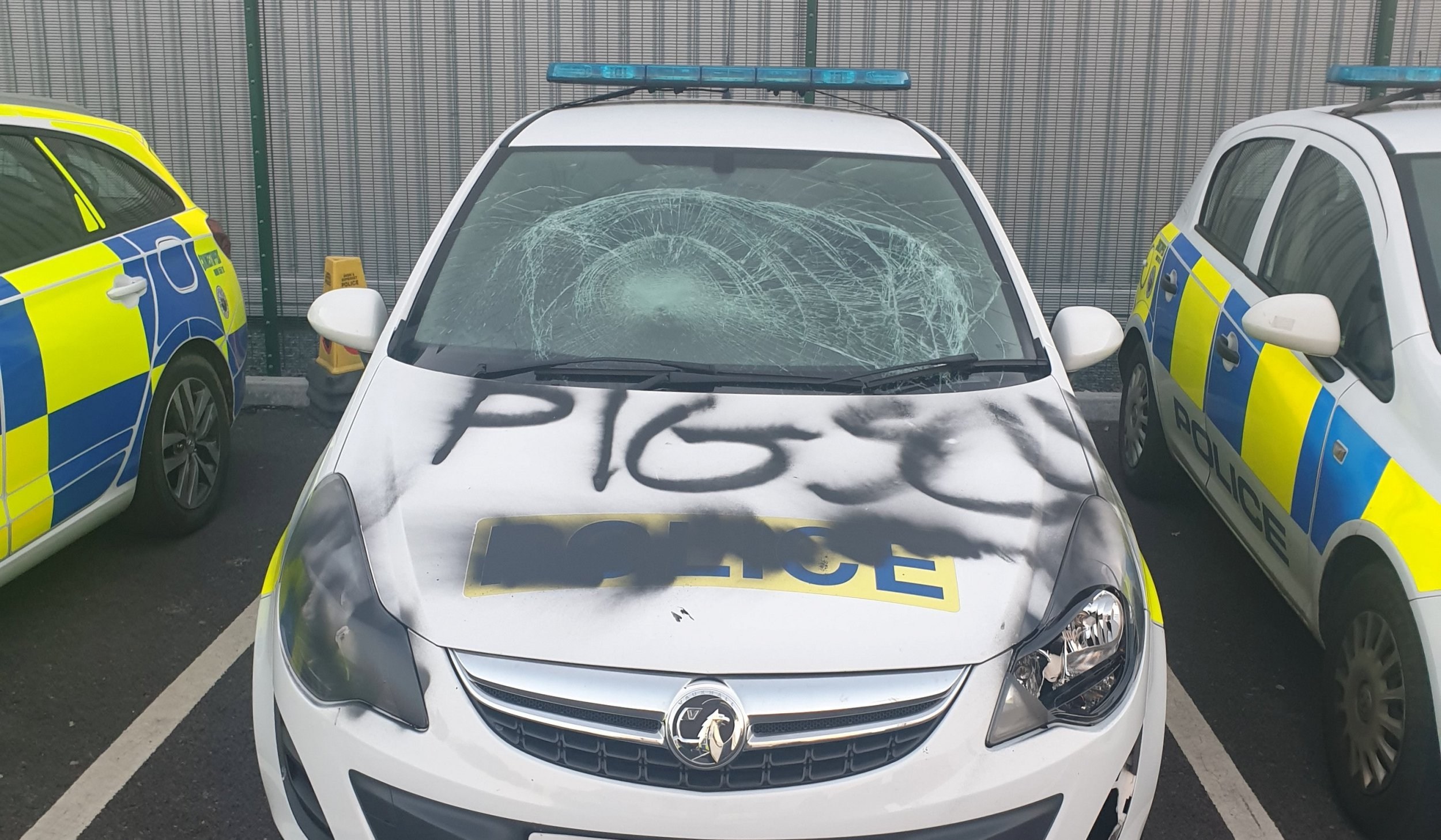 Two men arrested after police car covered with ‘pig scum’ graffiti