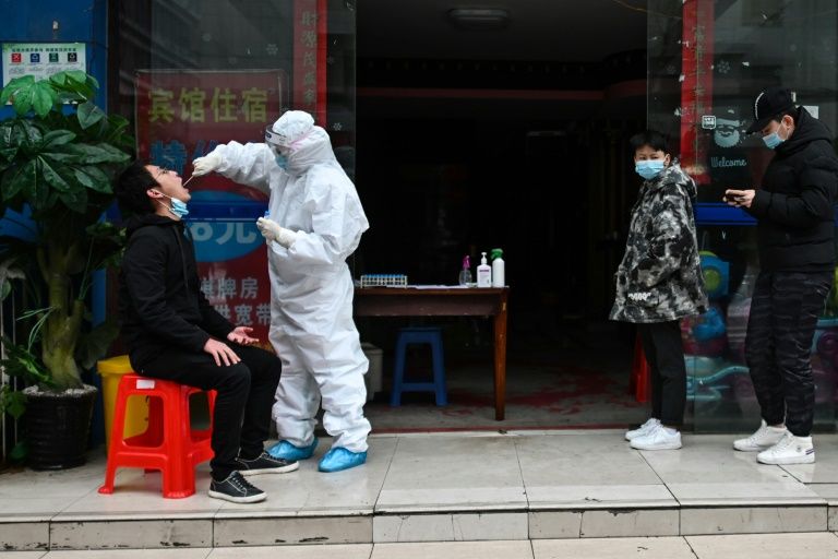 In schools and offices, China steps up virus tests