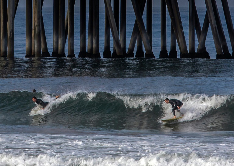 Surfers, sunbathers test waters as California closes Huntington Beach