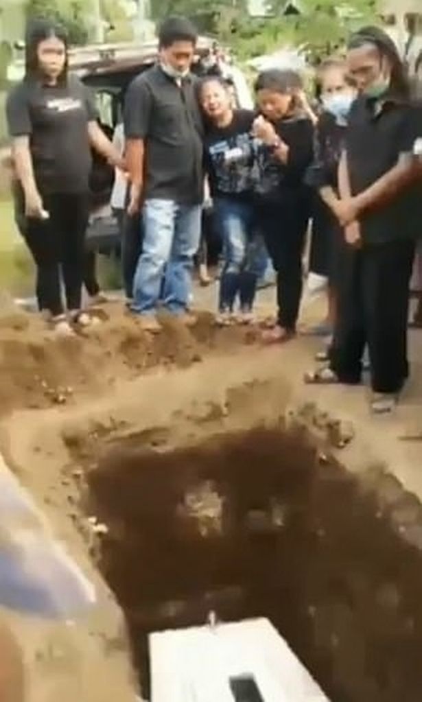 Terrifying moment corpse 'waves' from inside coffin sparks fears they were buried alive