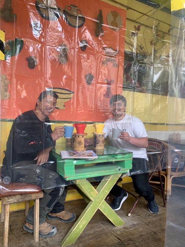Cafe owner prepares for post-lockdown life by separating tables with 35 shower curtains