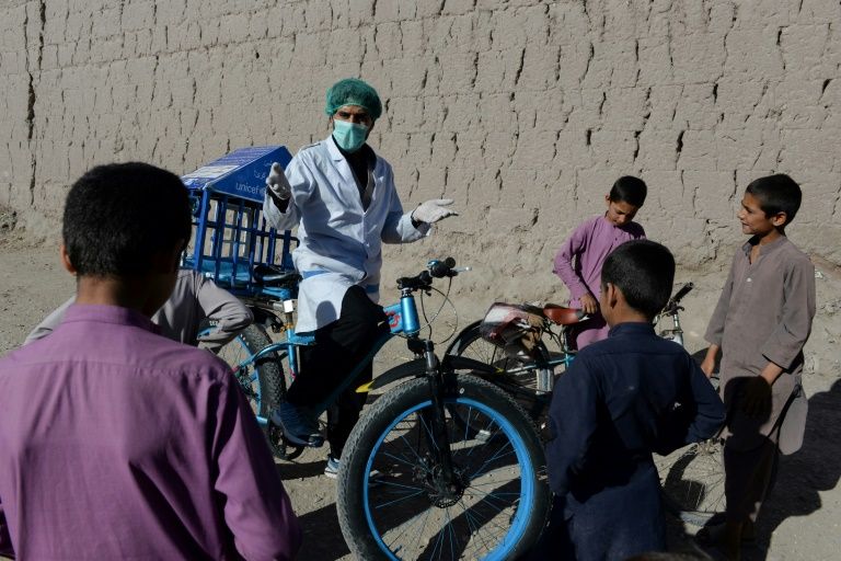 Afghan cyclist in 'door-to-door' campaign to curb virus