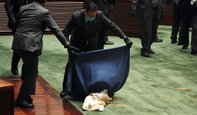 Hong Kong opposition lawmaker delays national anthem debate after throwing rotten plants at Legislative Council president