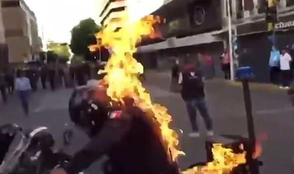 Police officer set on fire in disturbing attack during violent riots in Mexico - VIDEO