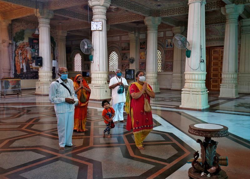 Mask-wearing worshippers in temples as India reopens amid rise in coronavirus cases