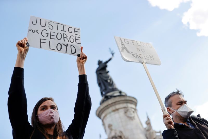 Anti-racism protesters take a knee in silence in Paris