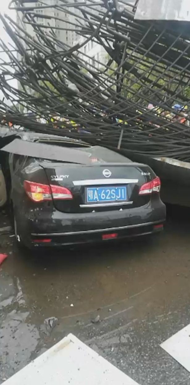 Huge crane collapses onto busy motorway trapping terrified woman in car