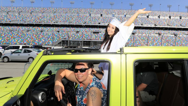 Thousands of grads collect diplomas from their cars at NASCAR tracks