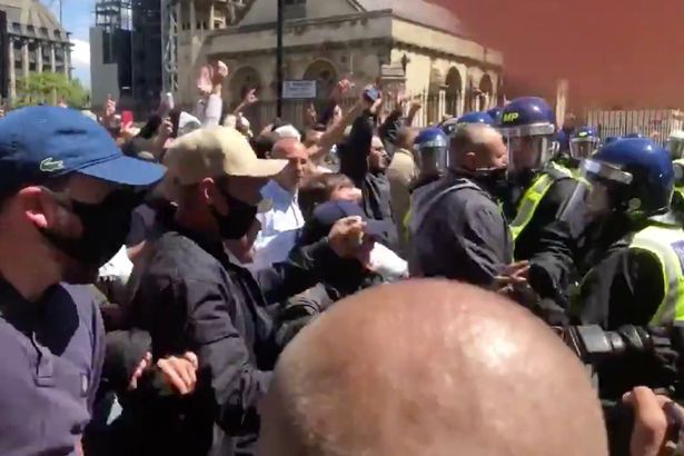 Thug punches police officer in face in horrifying video at London protests