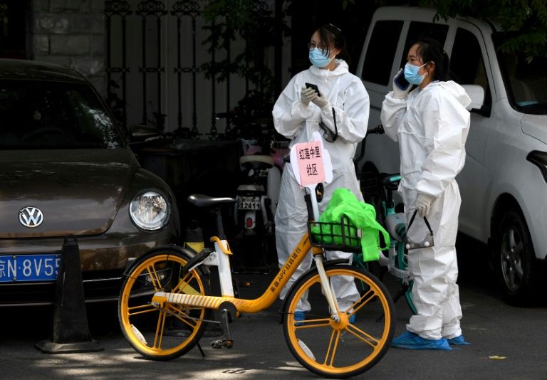 Beijing locks areas down as new virus outbreak gathers pace