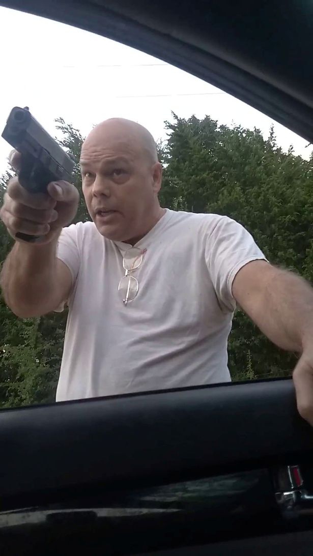 Terrifying footage shows enraged gunman firing at motorist who stopped on his driveway