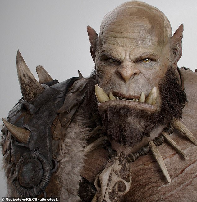 The human ORC: Tattooist has TUSKS fitted to complete his look as a fictional monster after undergoing huge range of painful body modifications