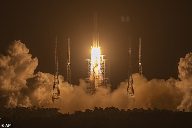 China flies its flag on the moon: Beijing flaunts picture of its national emblem on lunar surface as probe Chang'e-5 makes its return journey to Earth with rock samples