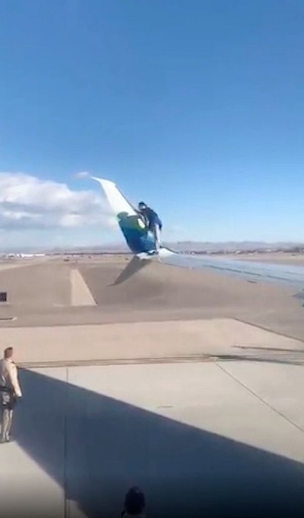 Man arrested after climbing onto wing of passenger jet moments before take-off