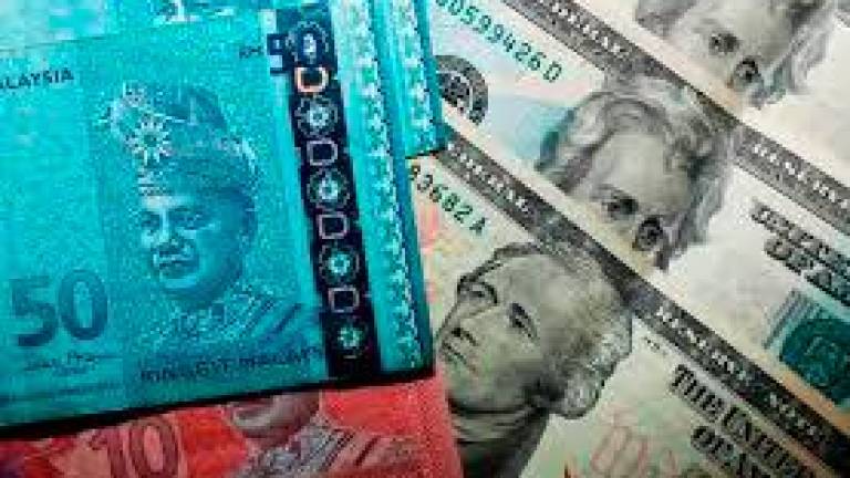 Ringgit pares earlier losses to end higher against US Dollar