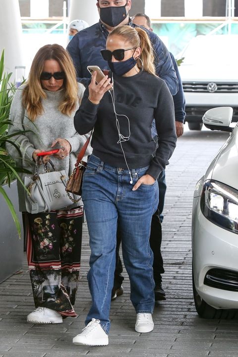Jennifer Lopez Keeps It Casual in Baggy Jeans, White Sneakers, and a Love Sweatshirt
