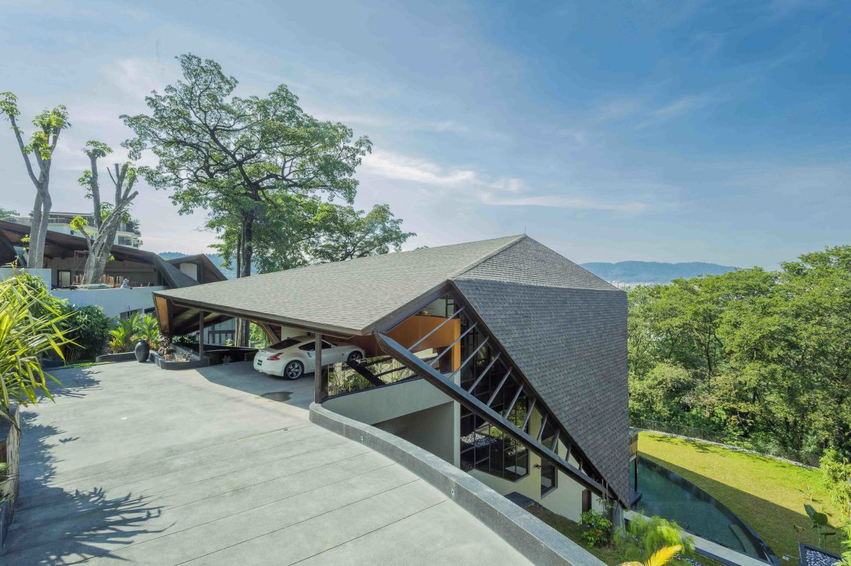 Two Malaysian houses whose unique roof designs are inspired by the canopy of rain trees