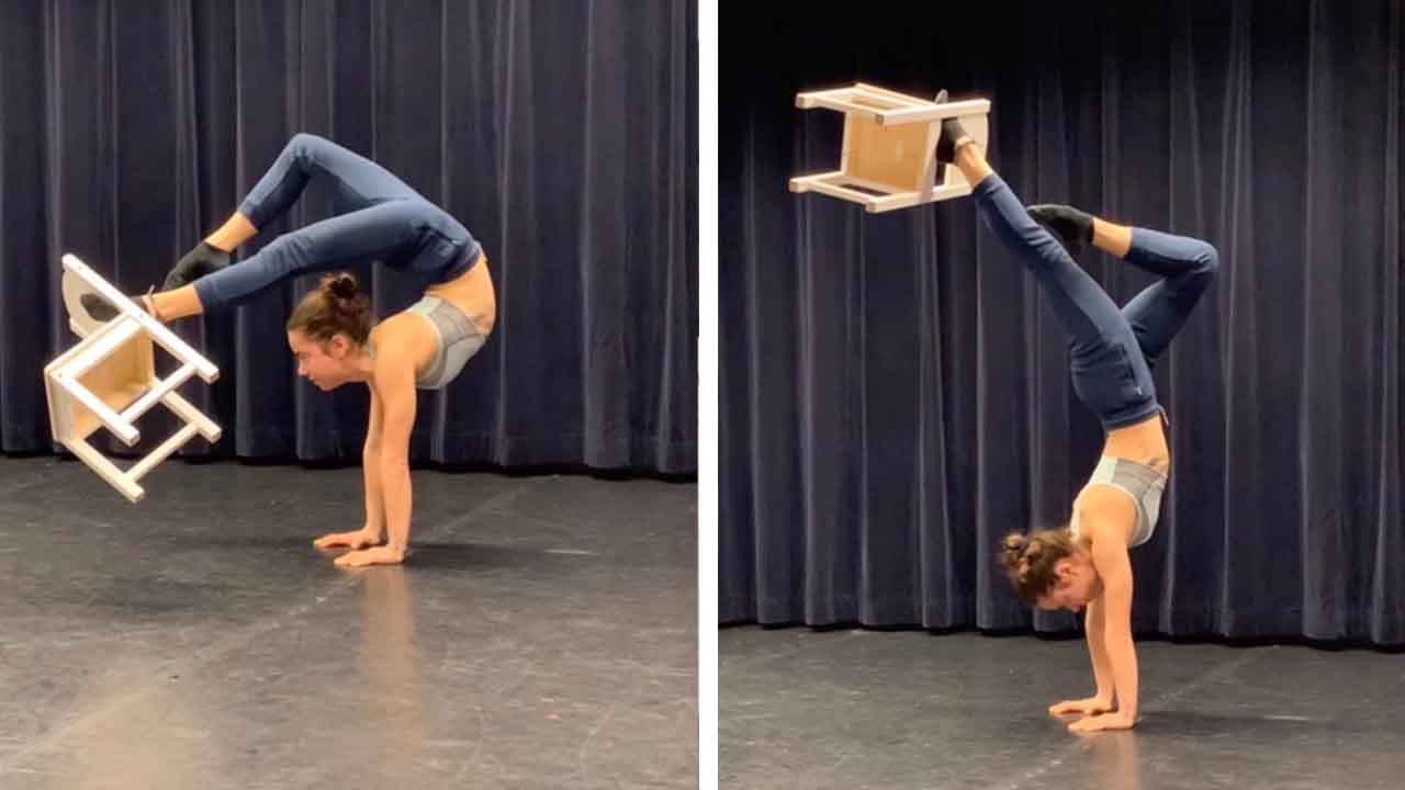 Acrobat Picks Chair Up With Foot Whilst Doing A Handstand