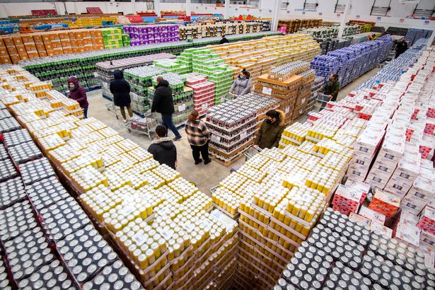 Bargain hunters queue up at 'gone past best' warehouse for half-price food