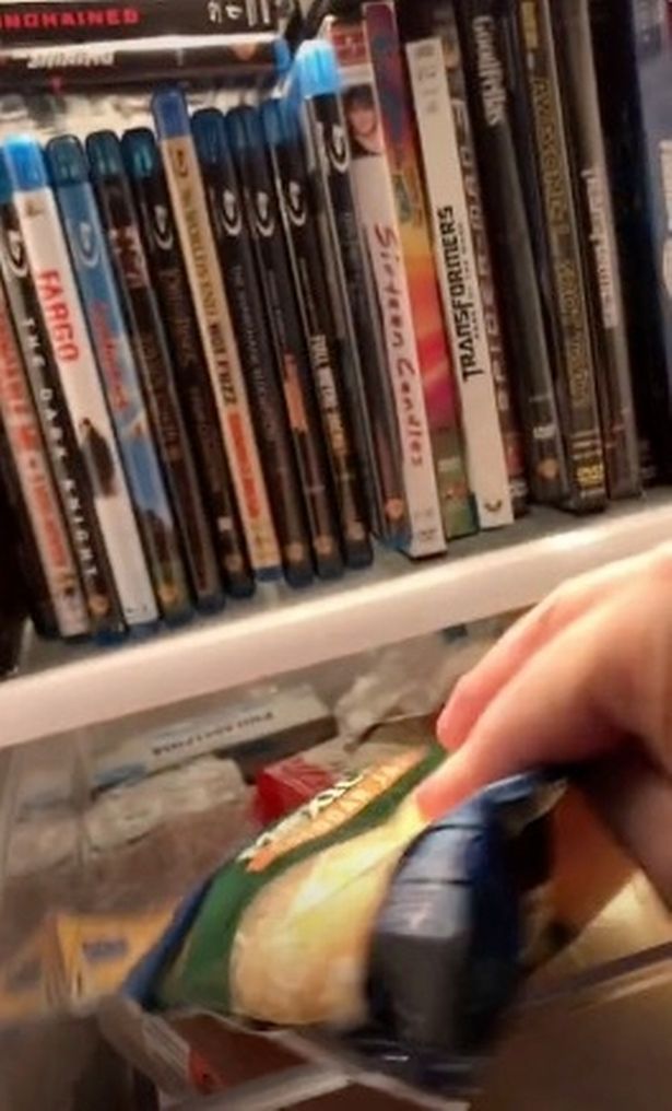 Man shows off cheese drawer in fridge but people can't get over DVDs on shelf above