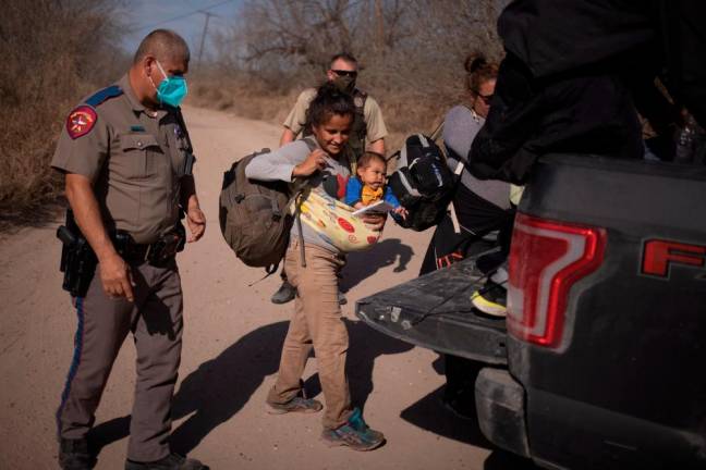 US detained nearly 100,000 migrants at Mexico border in February, sources say