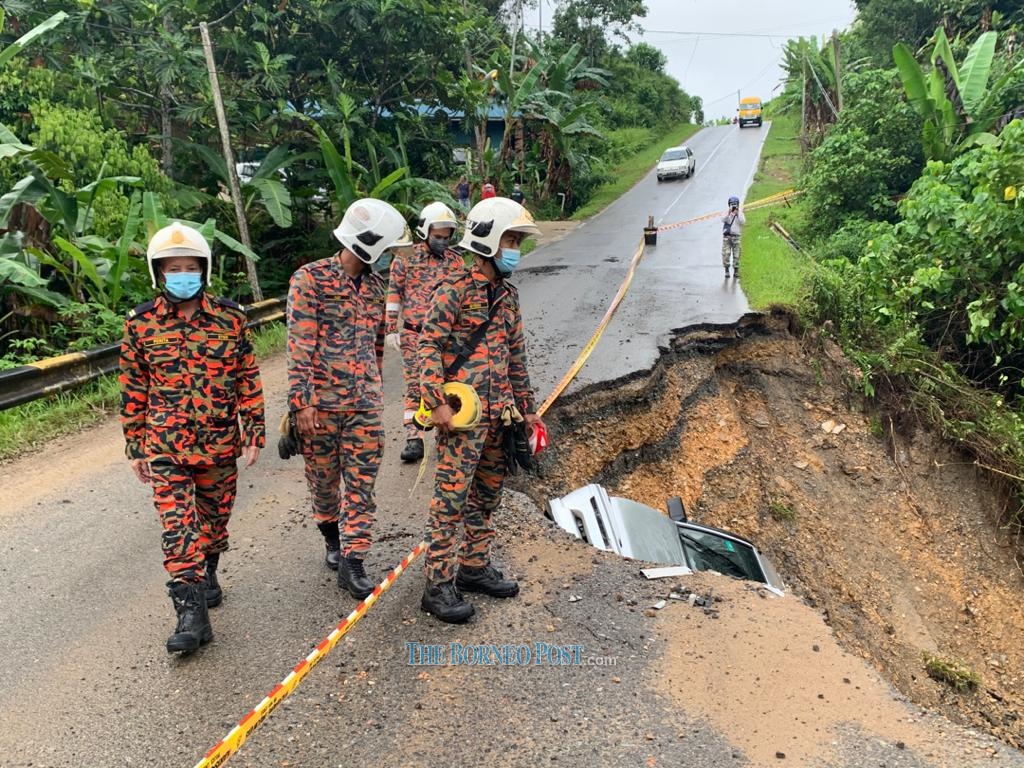 Narrow escape for two after escaping with minor injuries after car tumbles into caved-in section of Jalan Bukit Goram