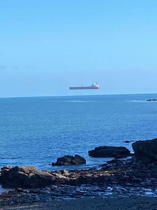 Ship captured 'floating in the sky' in bizarre optical illusion photo